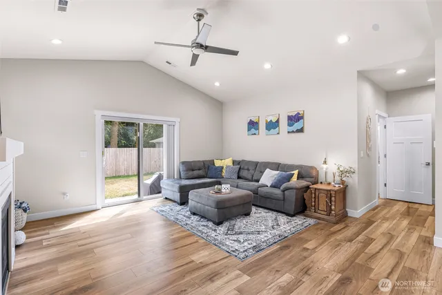 a living room with furniture and a ceiling fan