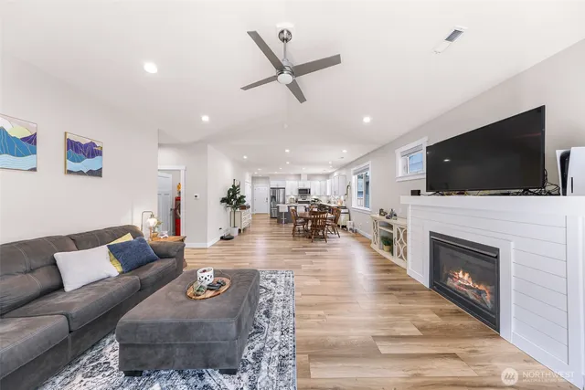 a living room with fireplace furniture and a flat screen tv