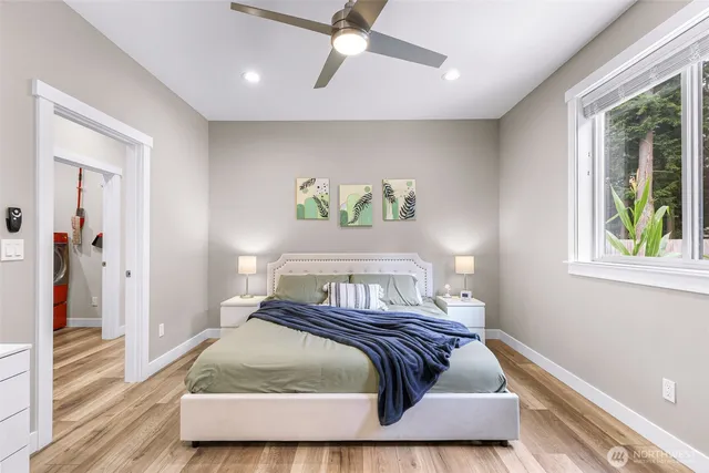 a bedroom with a bed and wooden floor