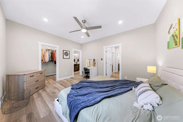 a bedroom with a bed and wooden floor