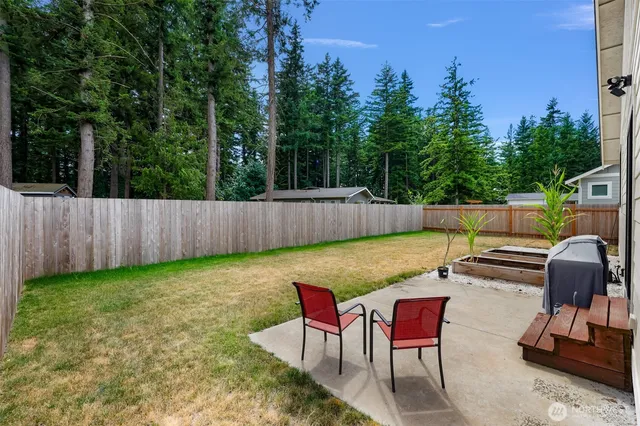 a backyard of a house with table and chairs