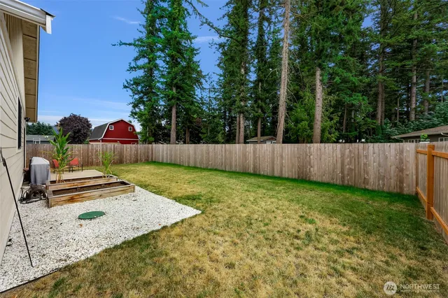 a view of a backyard with wooden fence