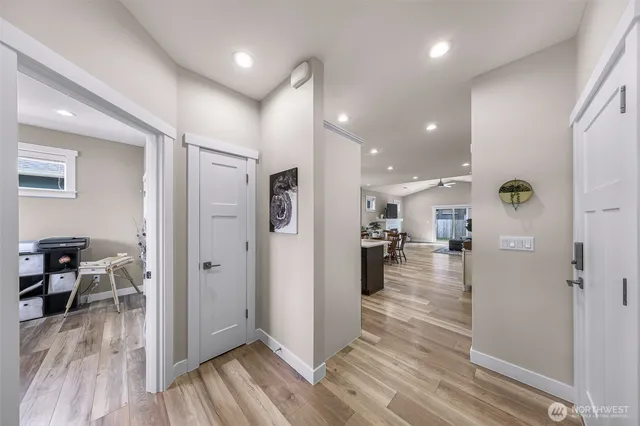a view of a hallway view with wooden floor and living room