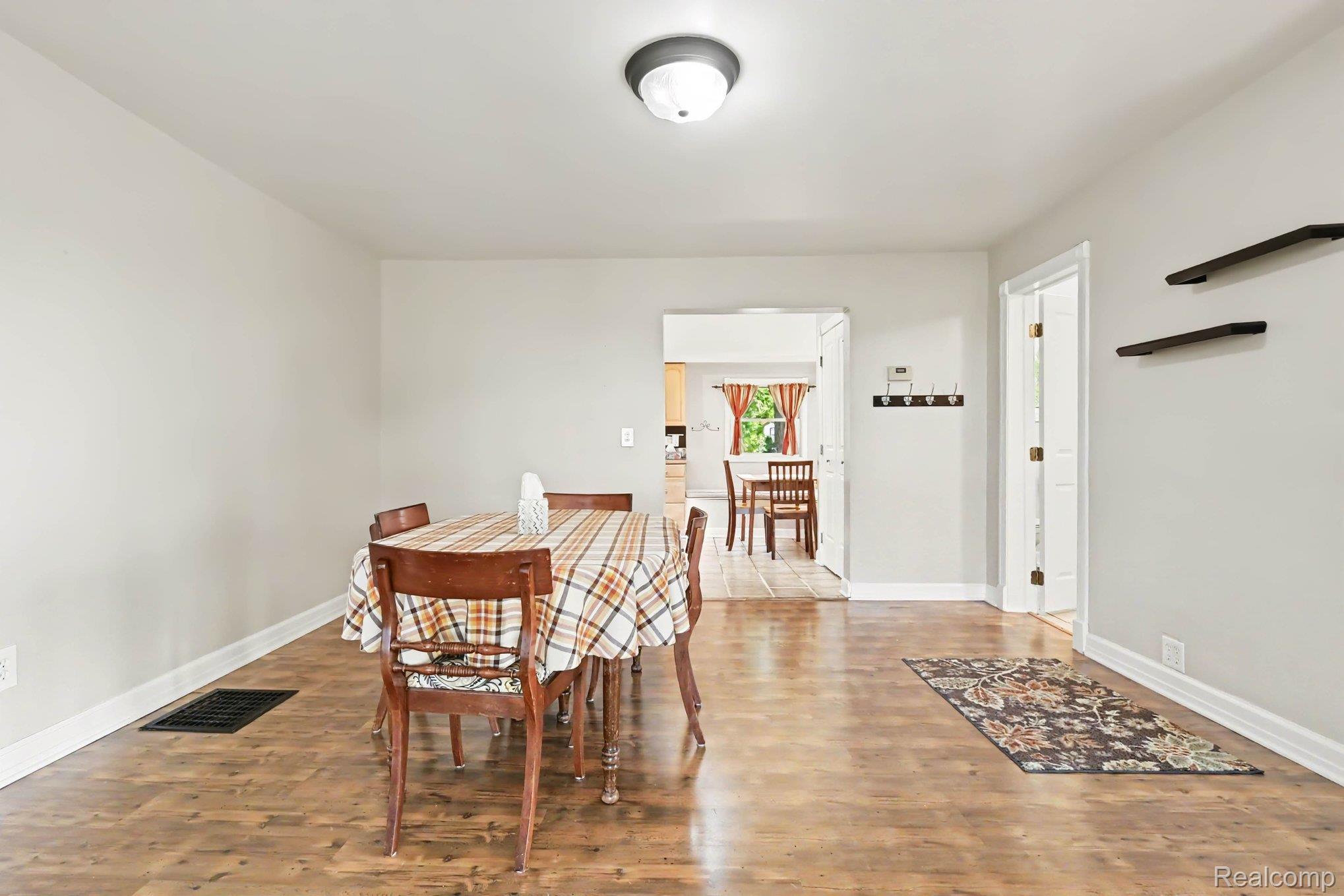 4815 Lytle Road Corunna, MI 48817 - Photo 9 of 31 Spacious interior featuring wood-finish flooring, light-toned walls, and white baseboards