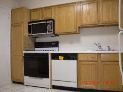 10353 Dearlove Road, Unit 5A Glenview, IL 60025 - Photo 7 of 9 a kitchen with a sink and a microwave