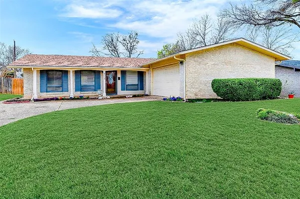 a view of a house with a yard and sitting area