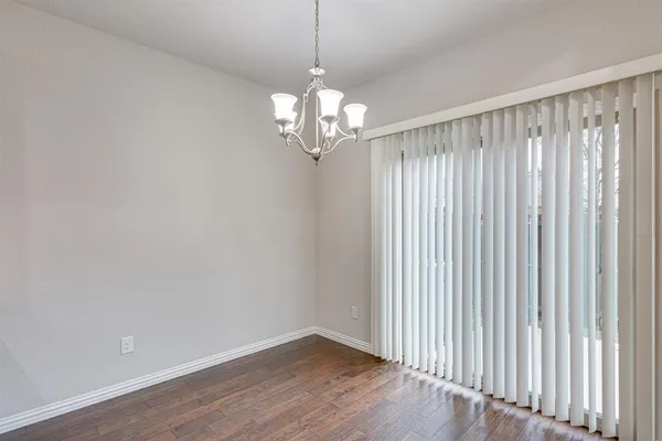a view of a chandelier fan and wooden floor