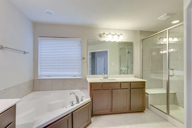 a view of an empty room with a chandelier fan
