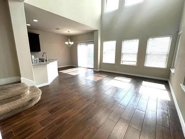 a view of entryway and kitchen with wooden floor