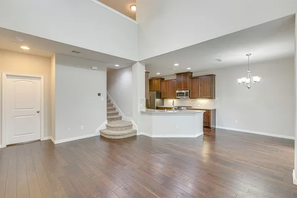 a view of kitchen with kitchen island white cabinets and stainless steel appliances