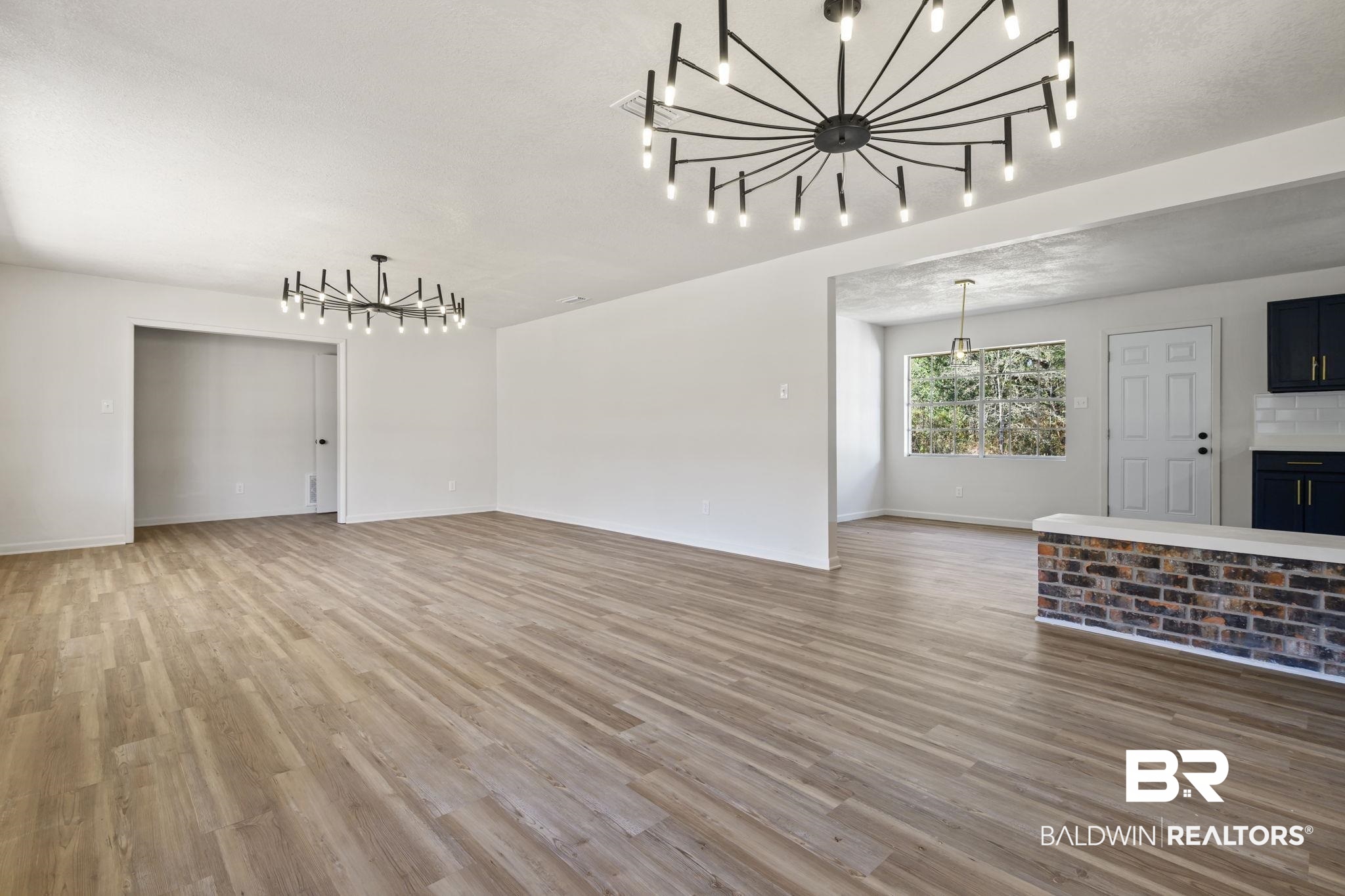 910 Moran Street Bay Minette, AL 36507 - Photo 4 of 20 Unfurnished living room with hanging lights and light wood finished floors