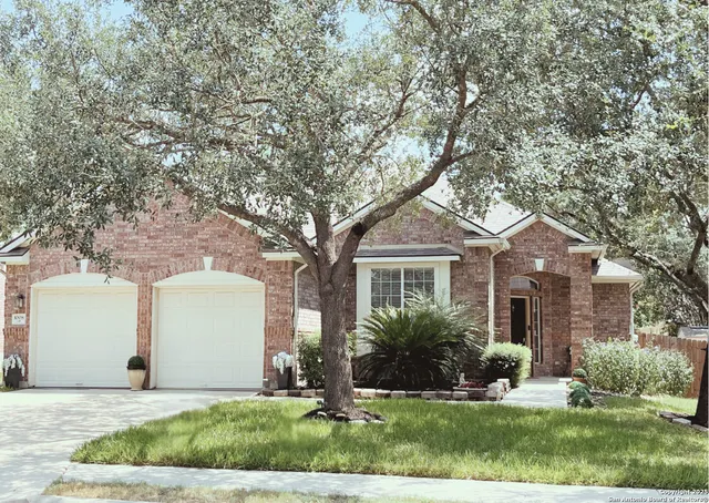 a front view of a house with a yard and a garage