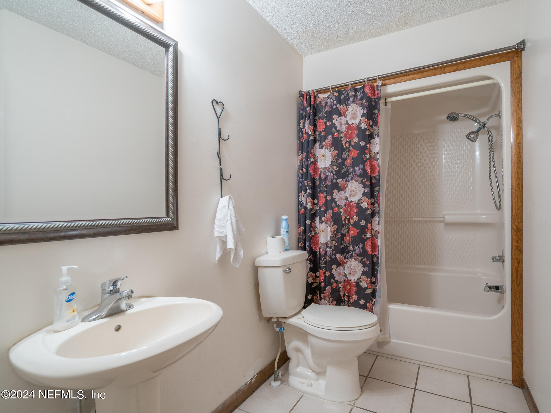27278 Inspiration Way Hilliard, FL 32046 - Photo 17 of 25 a bathroom with a sink toilet and shower