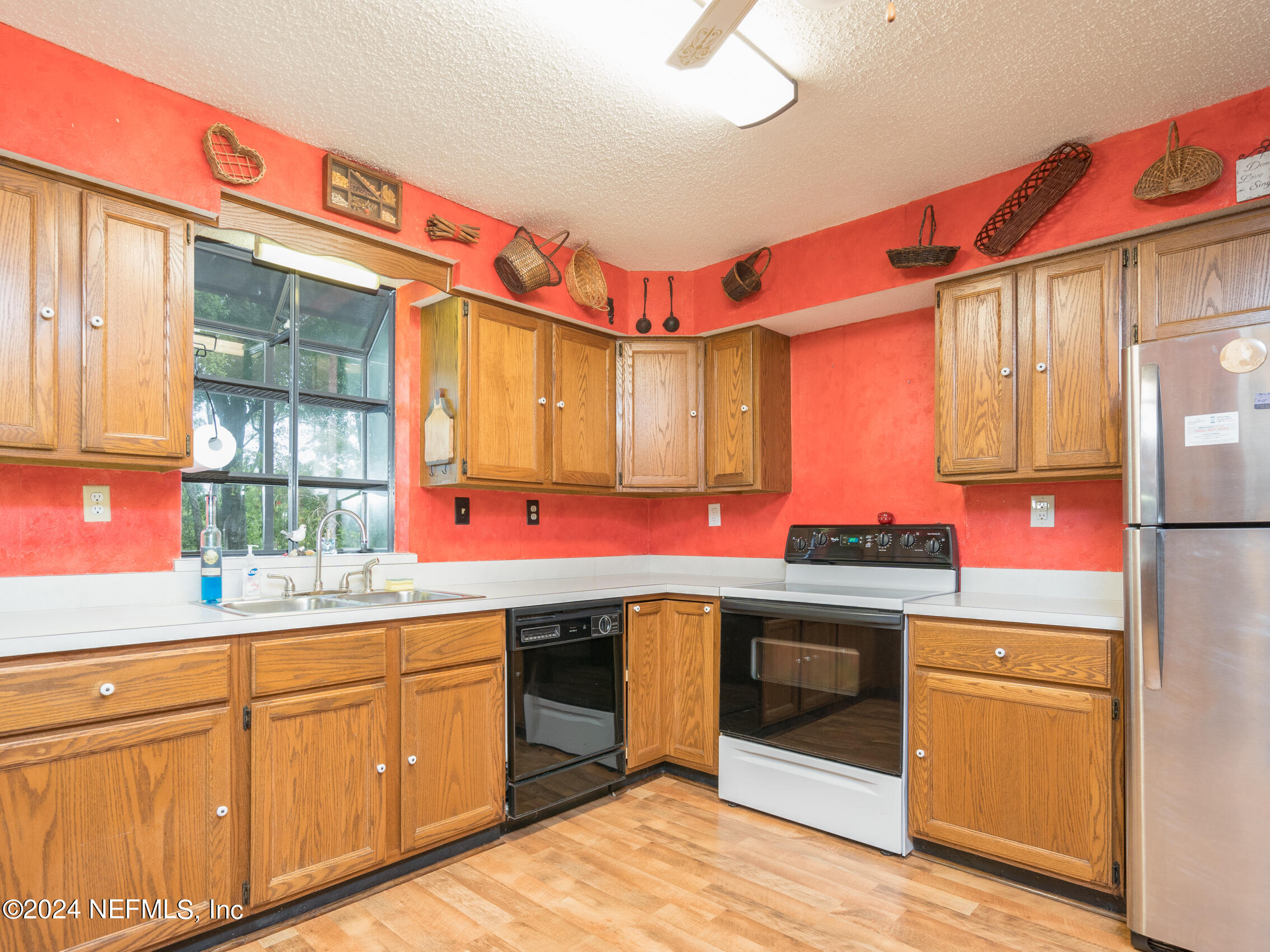 27278 Inspiration Way Hilliard, FL 32046 - Photo 22 of 25 a kitchen with stainless steel appliances granite countertop a sink and a stove