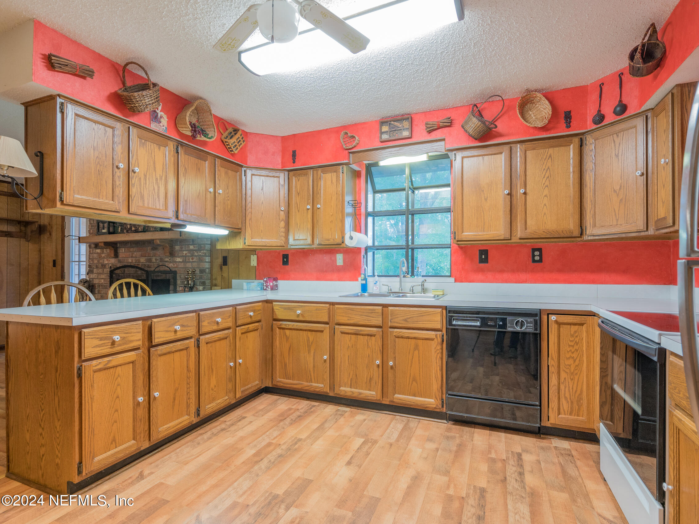 27278 Inspiration Way Hilliard, FL 32046 - Photo 23 of 25 a kitchen with granite countertop a sink window and cabinets