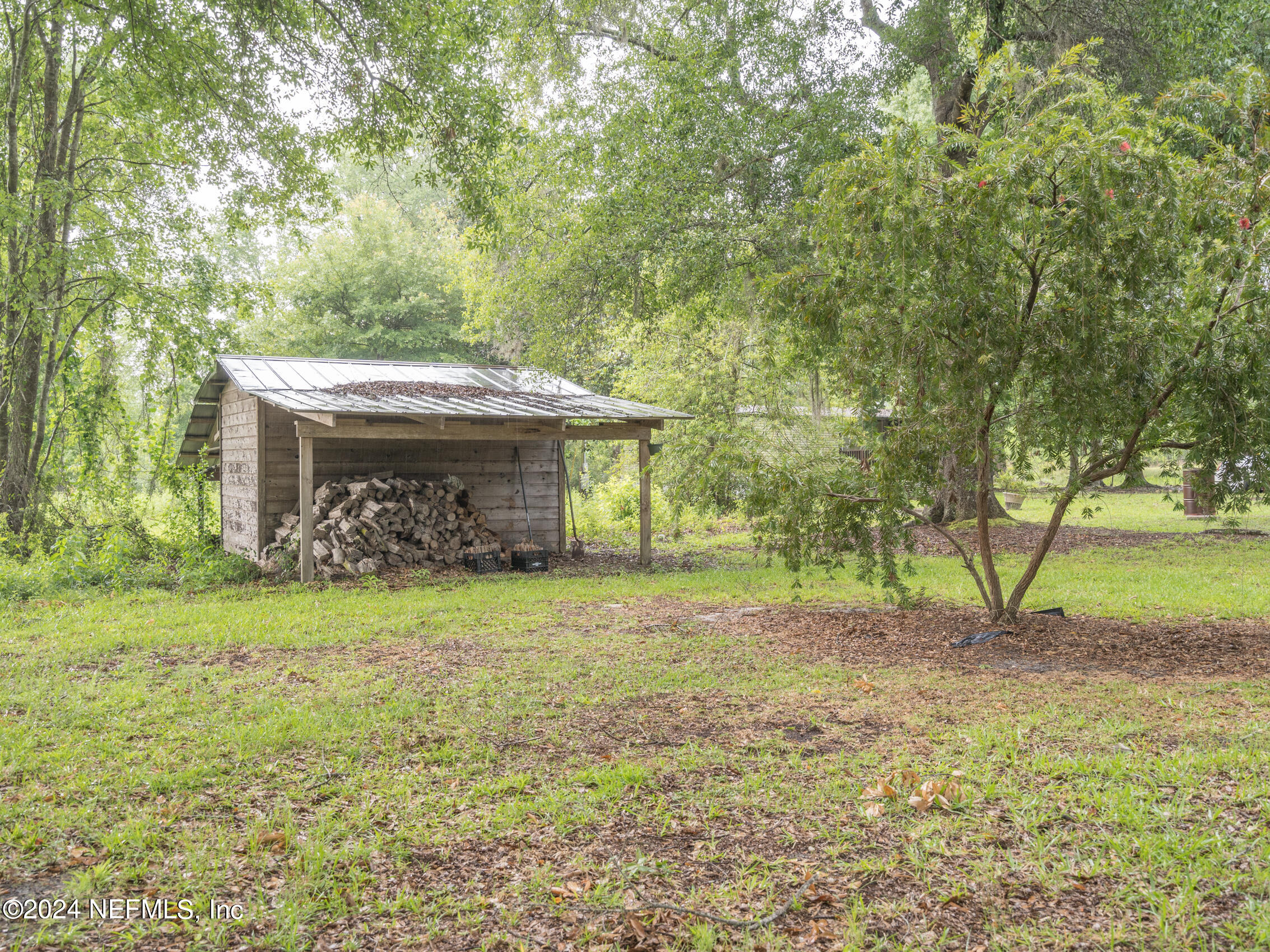 27278 Inspiration Way Hilliard, FL 32046 - Photo 3 of 25 a view of a house with a yard and a tree