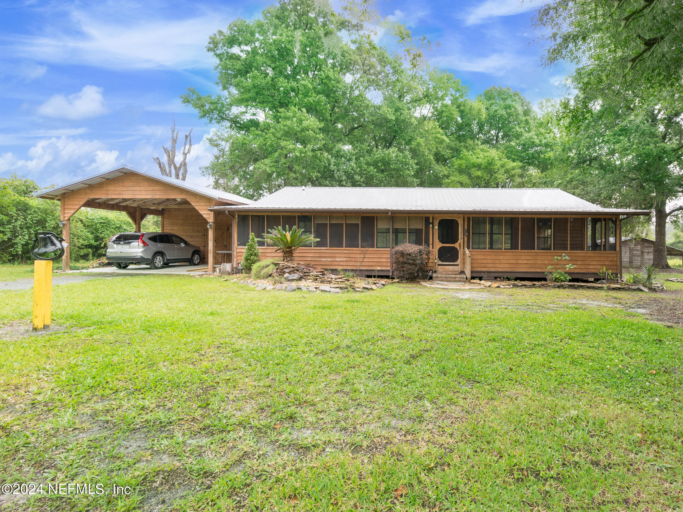 27278 Inspiration Way Hilliard, FL 32046 - Photo 9 of 25 a view of a house with a yard porch and sitting area