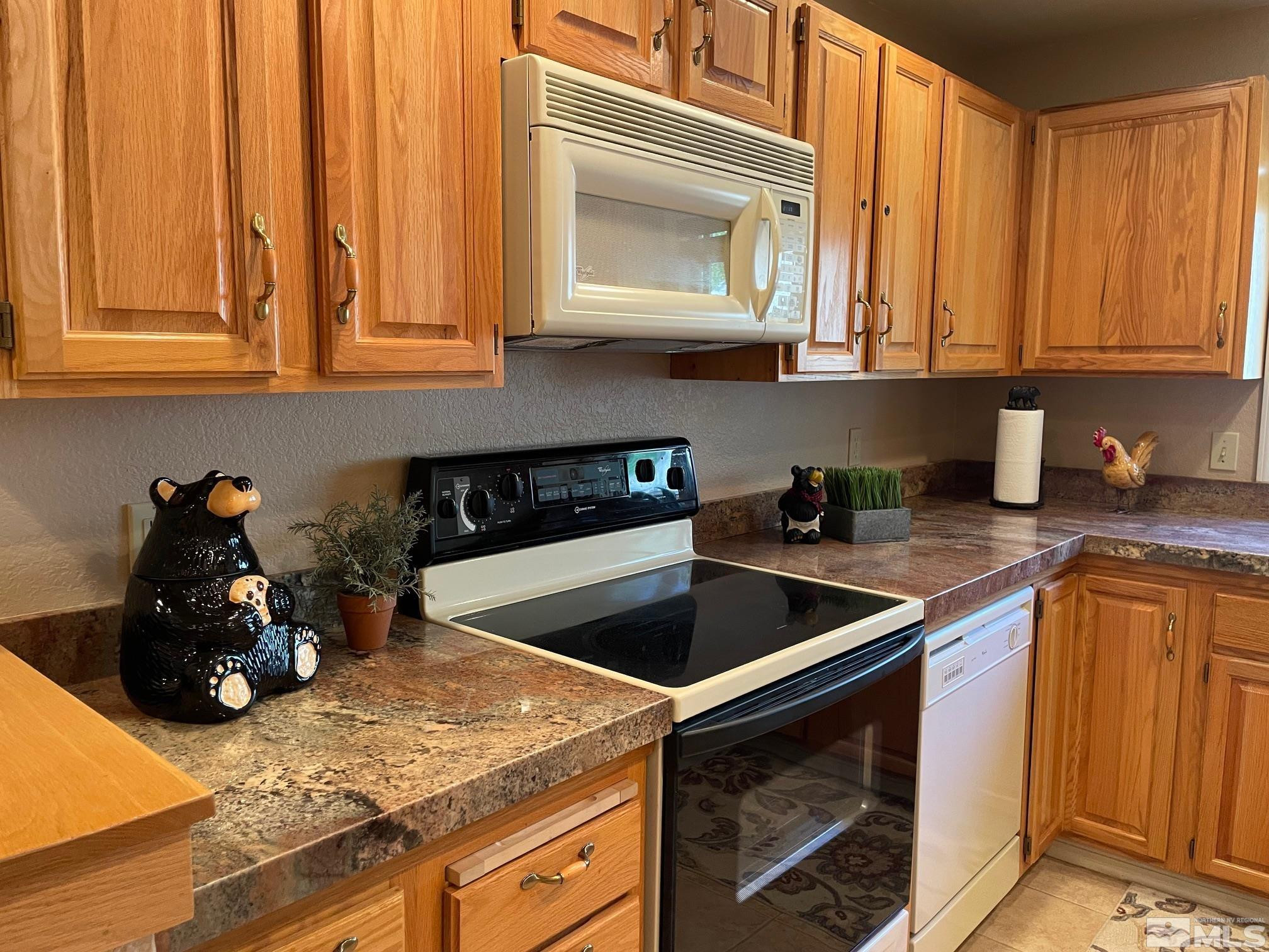 939 Incline Way, Unit 195 Incline Village, NV 89451 - Photo 6 of 17 a kitchen with stainless steel appliances granite countertop a sink stove and microwave