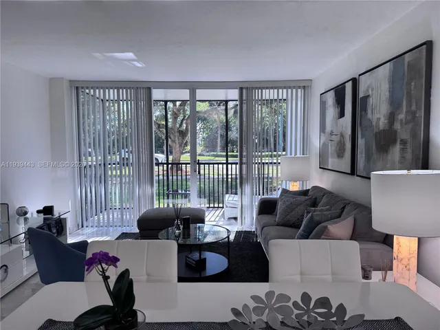 a living room with furniture and a painting on the wall