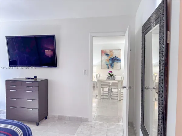 a view of a hallway with cabinet and cabinet