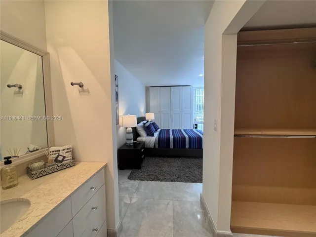 a bed room with a bed and a mirror