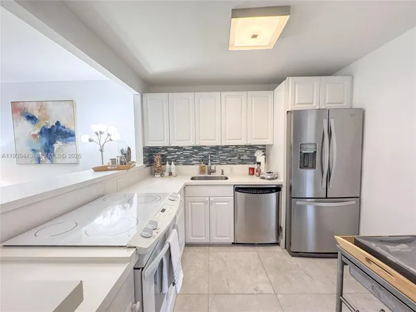 a kitchen with a refrigerator and a sink