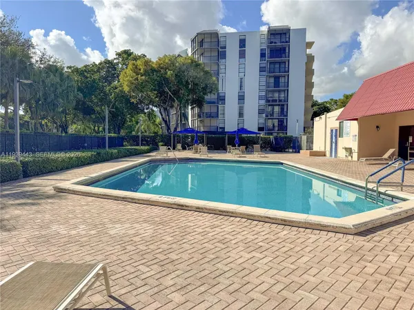 a view of a swimming pool with a yard