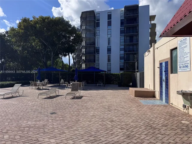 a building outdoor space with patio furniture and potted plants