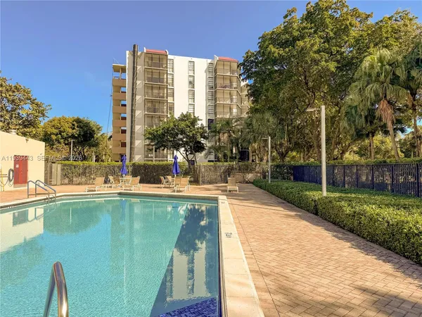 a view of swimming pool with outdoor seating and plants