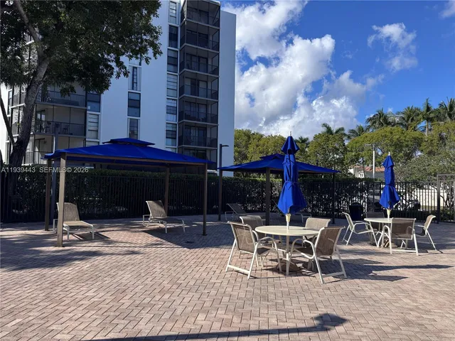 a view of a patio with a table and chairs