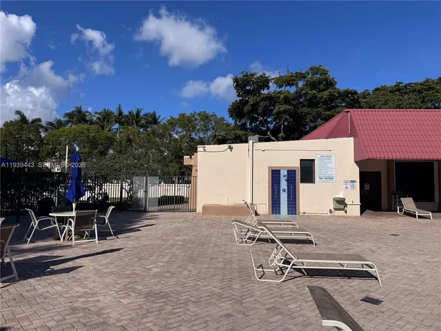 a view of swimming pool with outdoor seating and plants