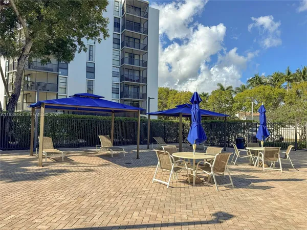 a patio with a table and chairs