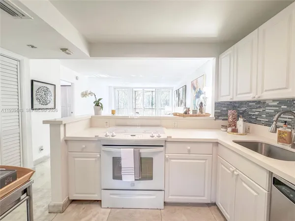 a kitchen with granite countertop a sink and cabinets