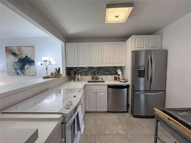 a kitchen with a refrigerator and a sink