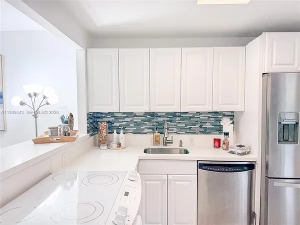 a kitchen with a sink stove and refrigerator