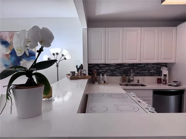 a kitchen with a refrigerator and a sink