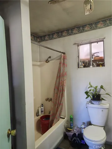 a bathroom with a toilet a sink and tub