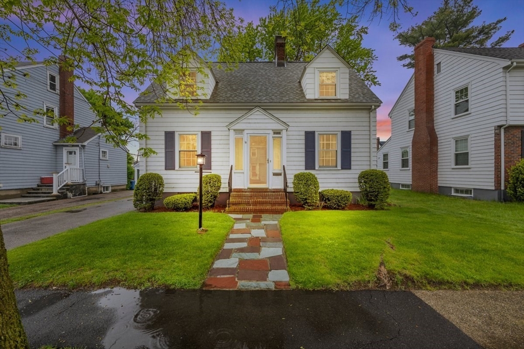 a front view of a house with garden