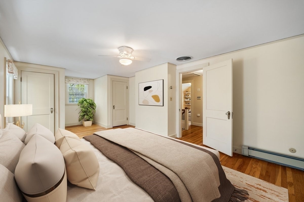 18 Bates Road Arlington, MA 02474 - Photo 17 of 42 a bedroom with a large bed and a chandelier