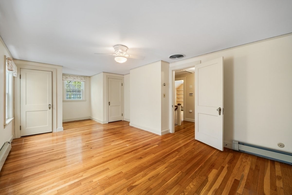 18 Bates Road Arlington, MA 02474 - Photo 18 of 42 a view of an empty room with window and wooden floor