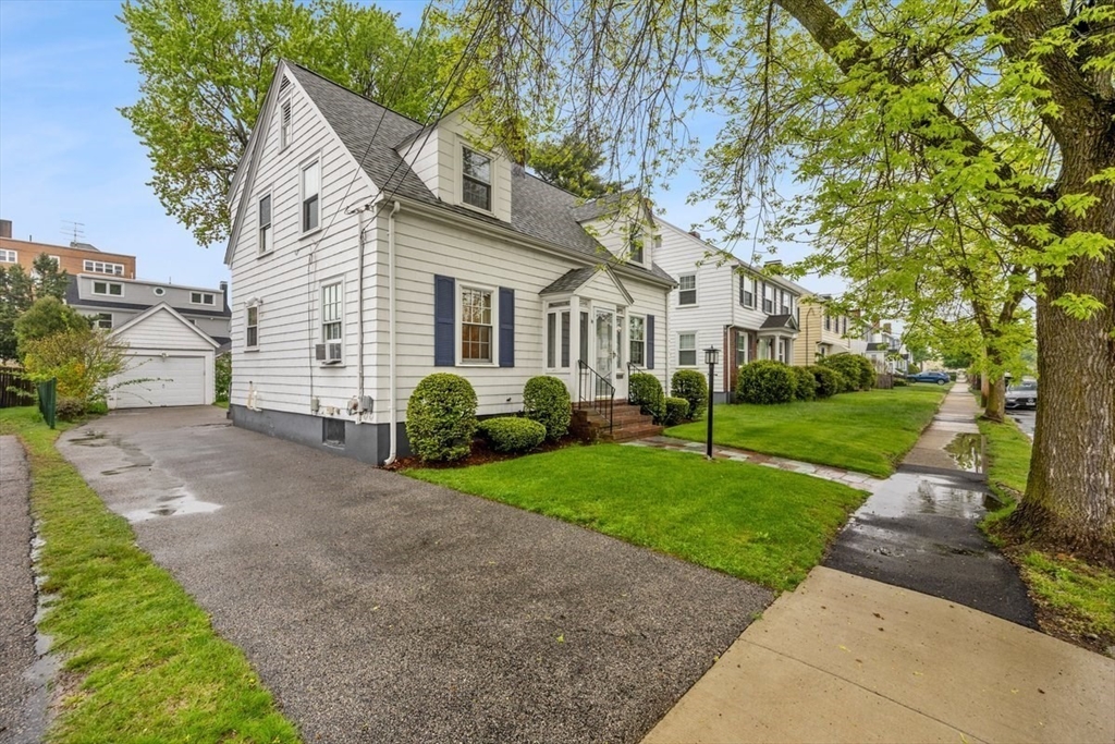18 Bates Road Arlington, MA 02474 - Photo 33 of 42 a front view of a house with a yard and trees