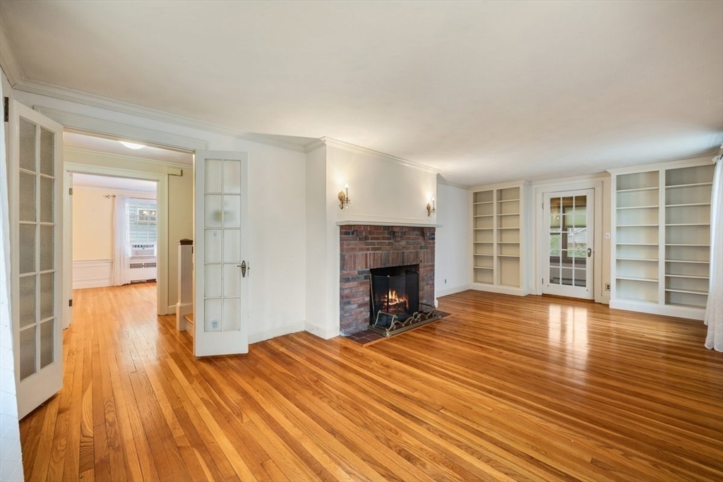 18 Bates Road Arlington, MA 02474 - Photo 7 of 42 a view of a livingroom with wooden floor and a fireplace