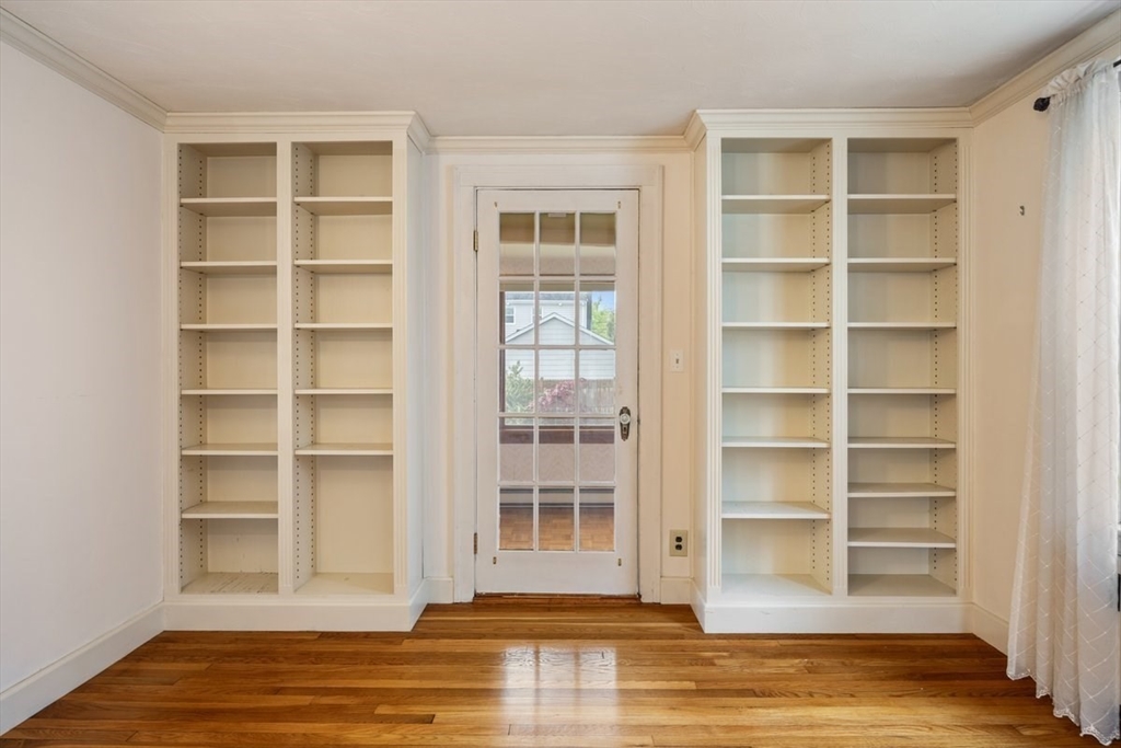 18 Bates Road Arlington, MA 02474 - Photo 9 of 42 a view of a room with wooden floor and shelves