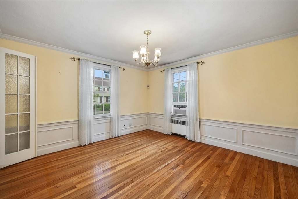 18 Bates Road Arlington, MA 02474 - Photo 10 of 42 wooden floor in an empty room with a window
