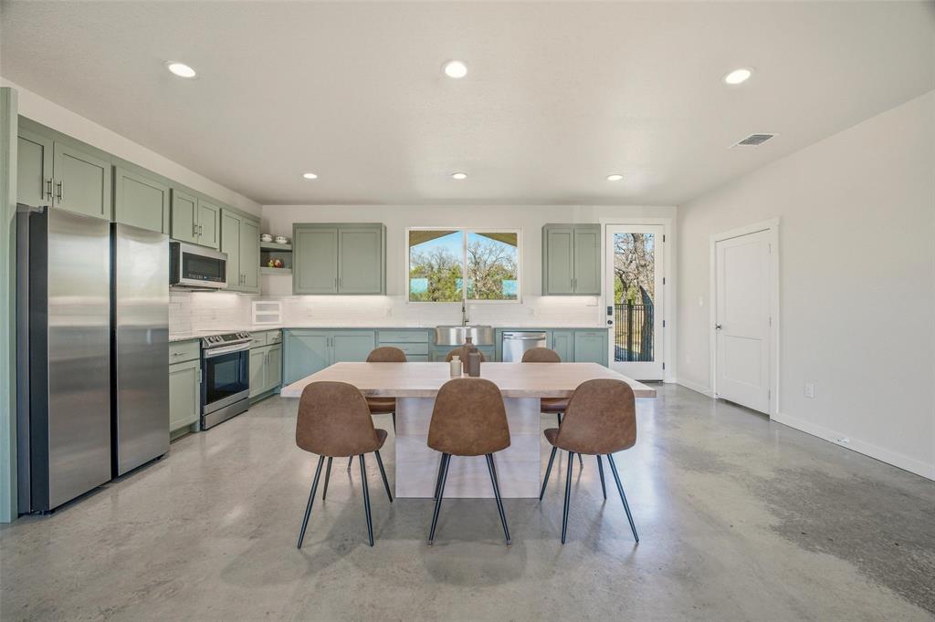 1525 North Bosley Road Santo, TX 76472 - Photo 11 of 40 a view of a dining room with furniture and a large window