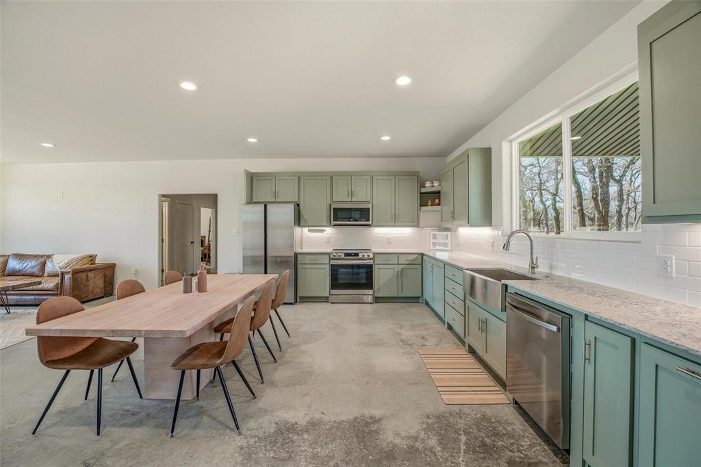 1525 North Bosley Road Santo, TX 76472 - Photo 13 of 40 a large kitchen with a table and chairs