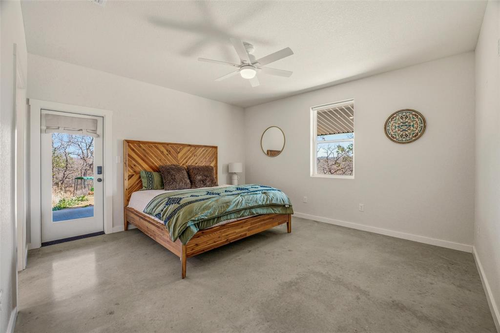 1525 North Bosley Road Santo, TX 76472 - Photo 15 of 40 a bedroom with a bed and painting on the wall