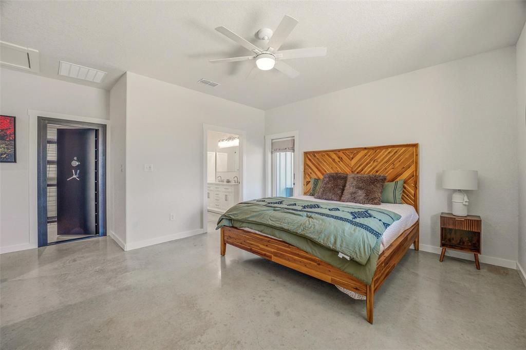 1525 North Bosley Road Santo, TX 76472 - Photo 16 of 40 a bedroom with a bed and a ceiling fan