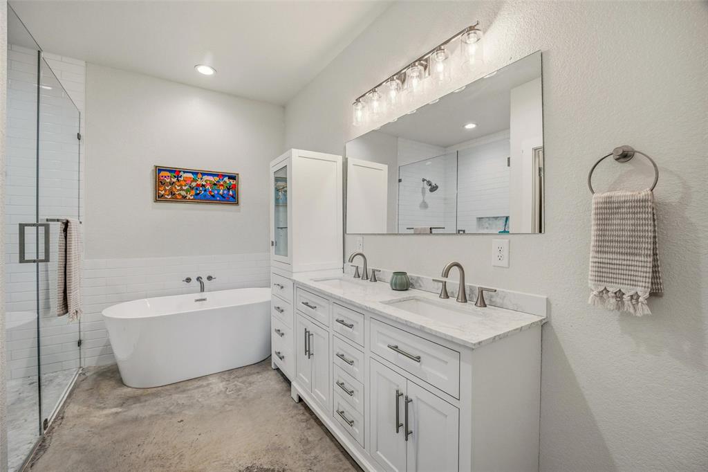 1525 North Bosley Road Santo, TX 76472 - Photo 17 of 40 a bathroom with a double vanity sink mirror and bathtub