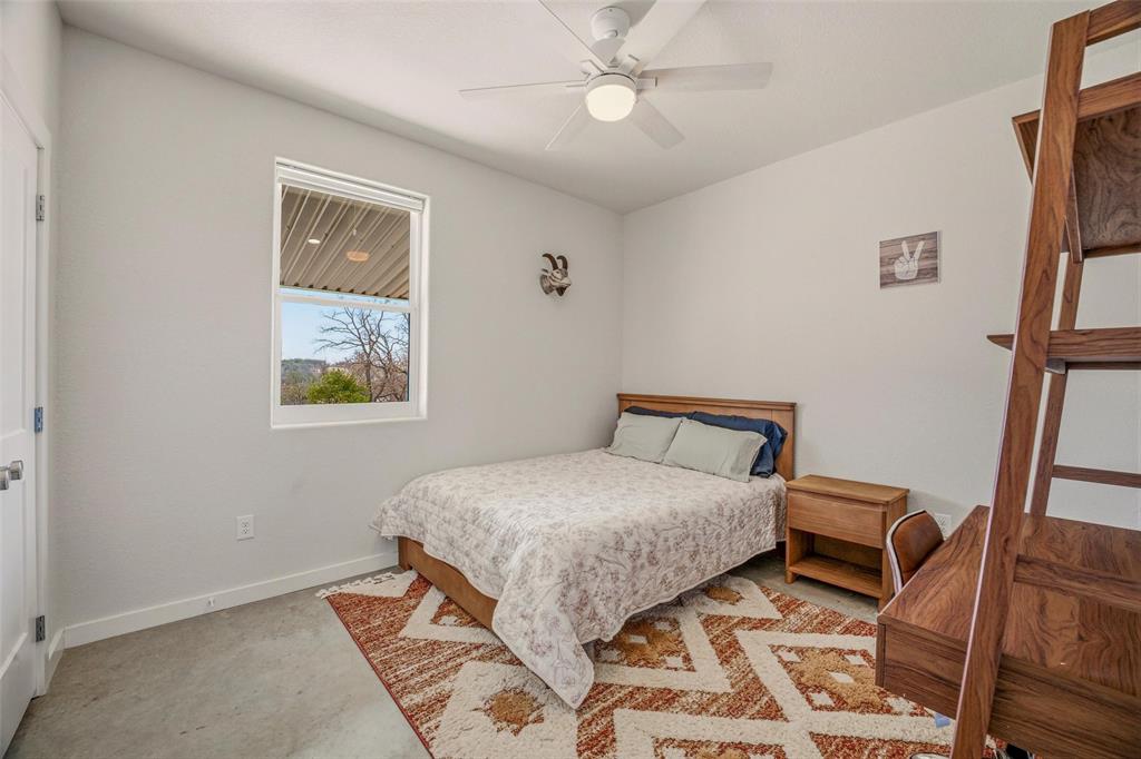 1525 North Bosley Road Santo, TX 76472 - Photo 23 of 40 a bedroom with a bed and a painting on the wall